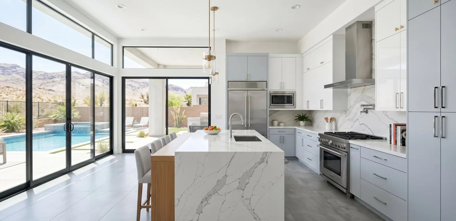 Luxury kitchen remodel with a waterfall-edge island and Las Vegas mountain views by Maintenance America