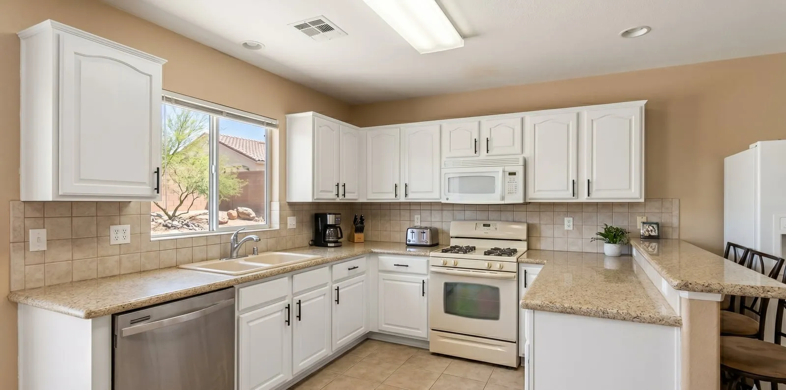 Kitchen cabinets refinished in clean white by Maintenance America in Las Vegas