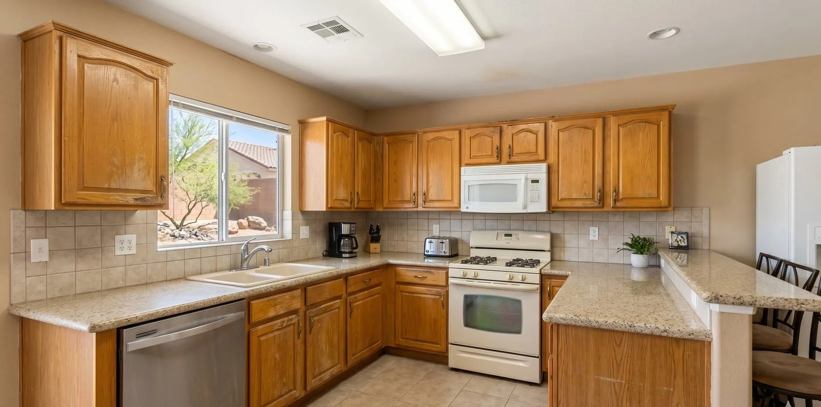 Dated honey-oak kitchen cabinets before refinishing