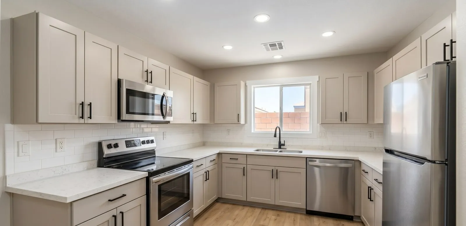 Refreshed kitchen with new shaker cabinets, quartz counters, and stainless appliances by Maintenance America